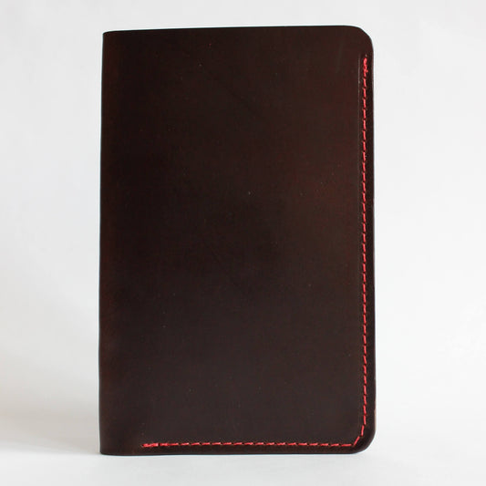 Brown leather wallet with red stitching on a white background