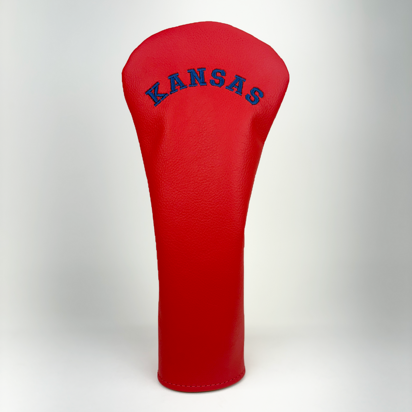 Red golf club head cover with 'Kansas' text on a white background