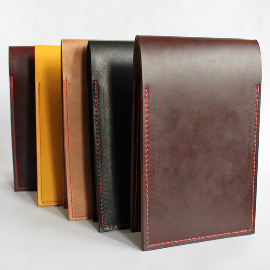 Set of leather yardage book covers in various colors on a white background