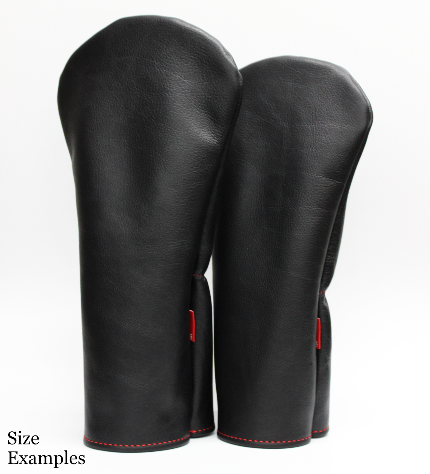 Pair of black leather golf covers with red stitching on a white background