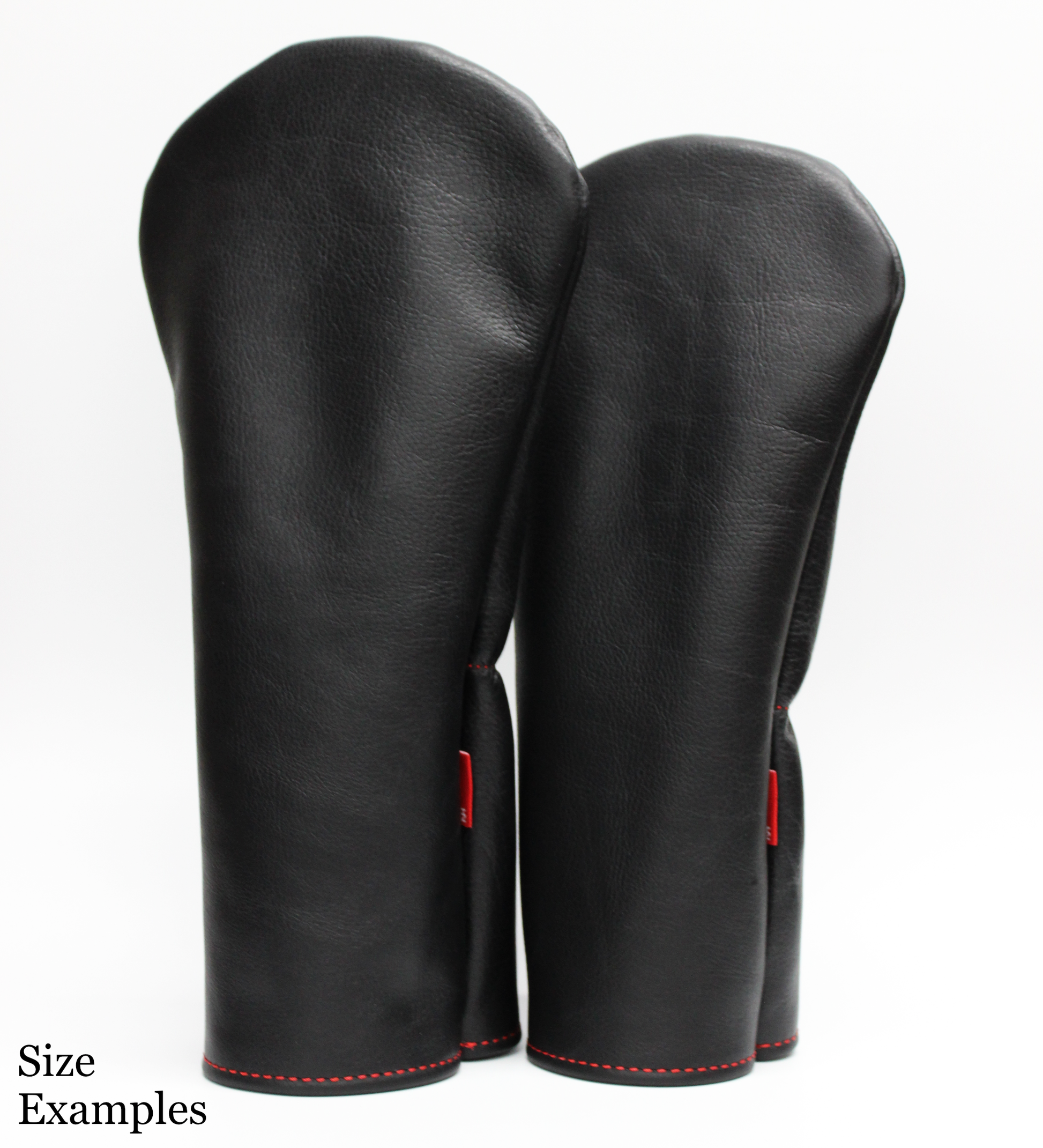 Pair of black leather golf covers with red stitching on a white background