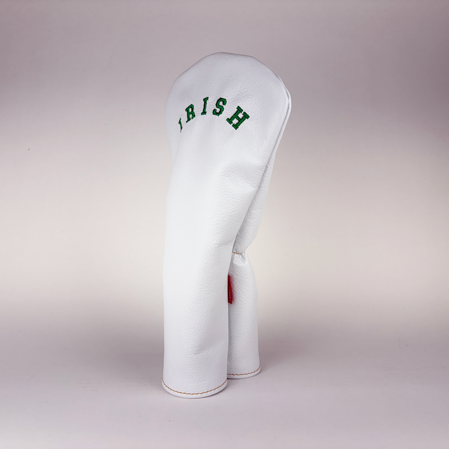 White golf club head cover with 'Irish' text on a light gray background