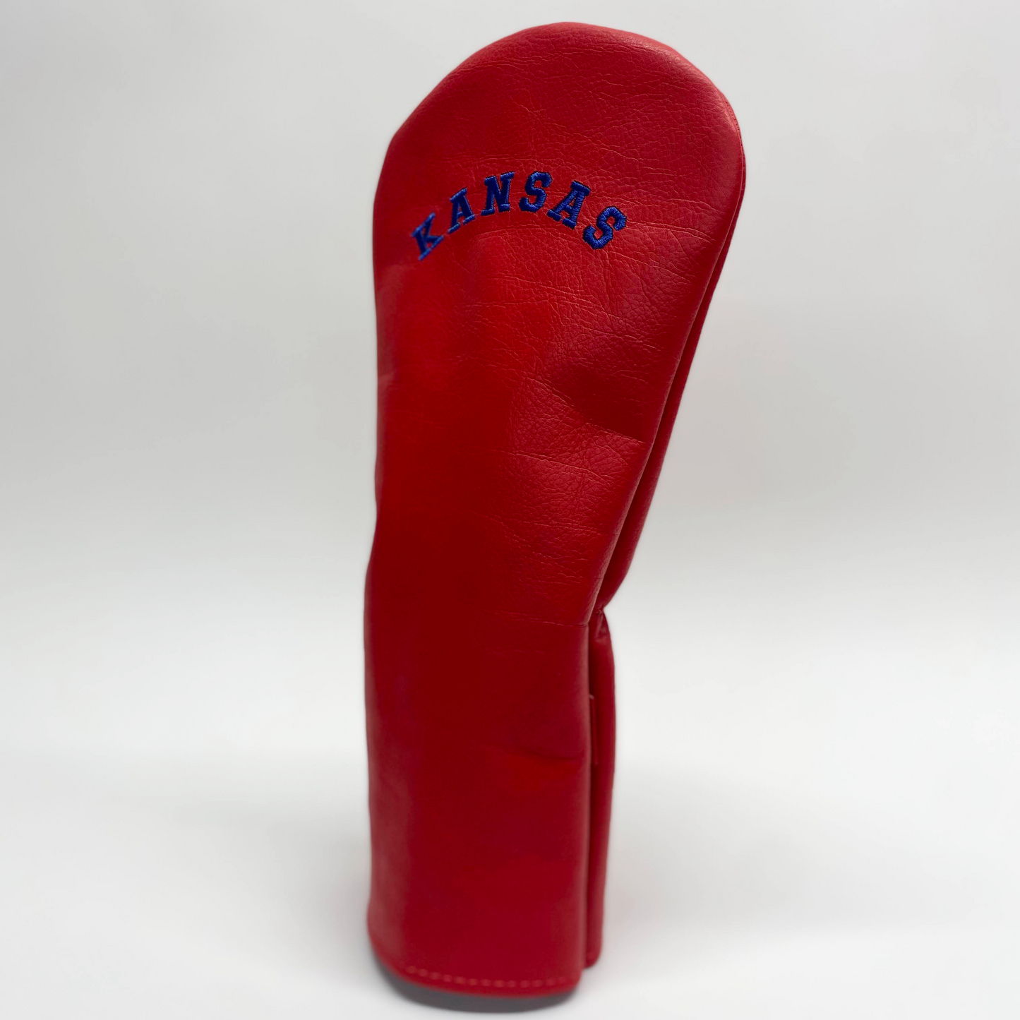 Red golf club head cover with 'Kansas' text on a white background