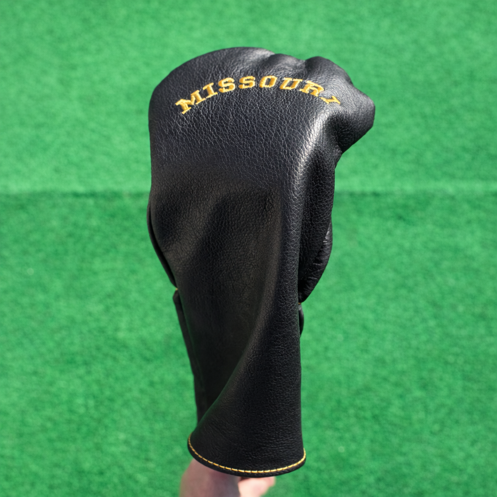 Black golf club head cover with 'Missouri' text on a green background