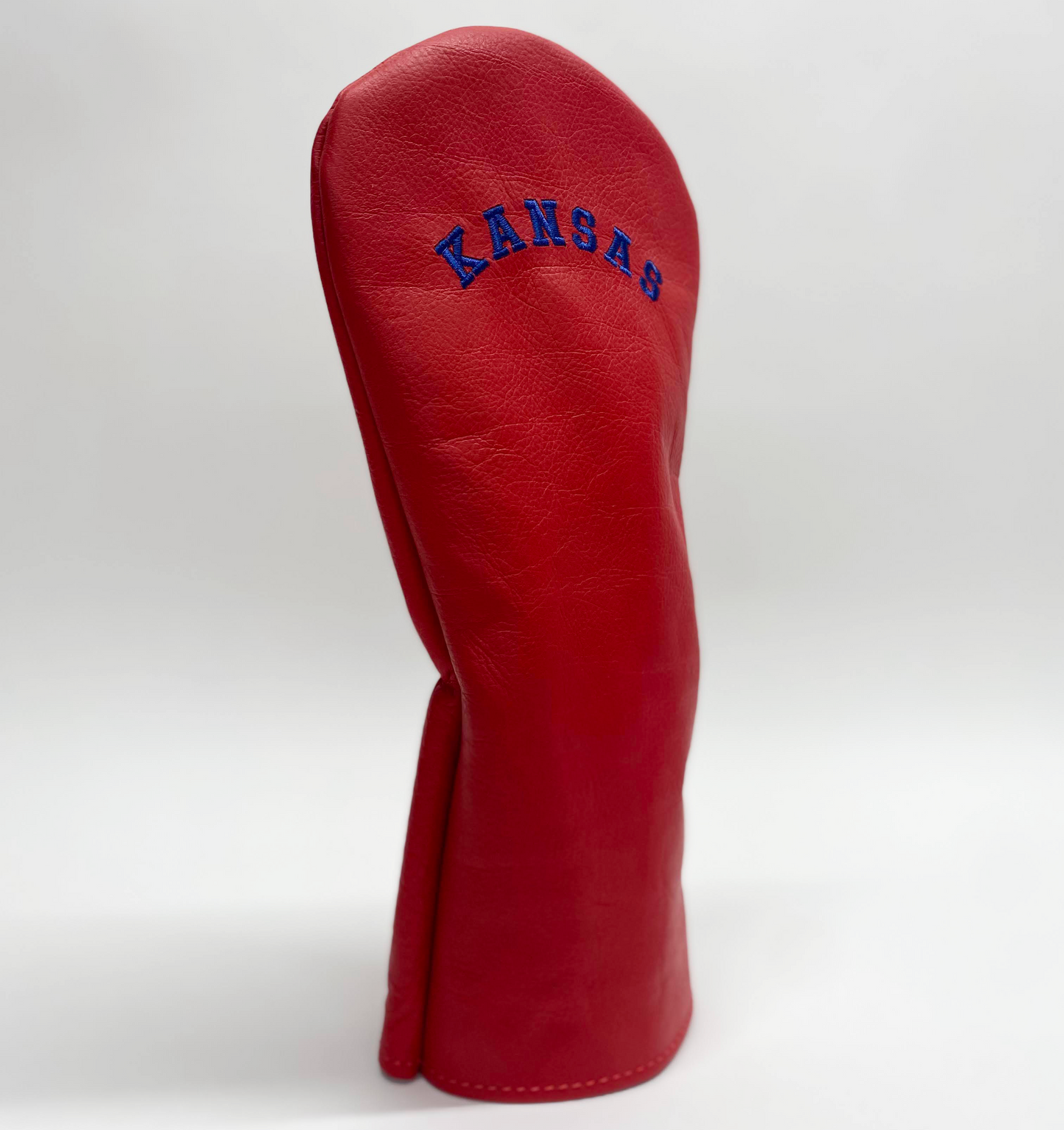 Red golf club head cover with 'Kansas' branding on a white background