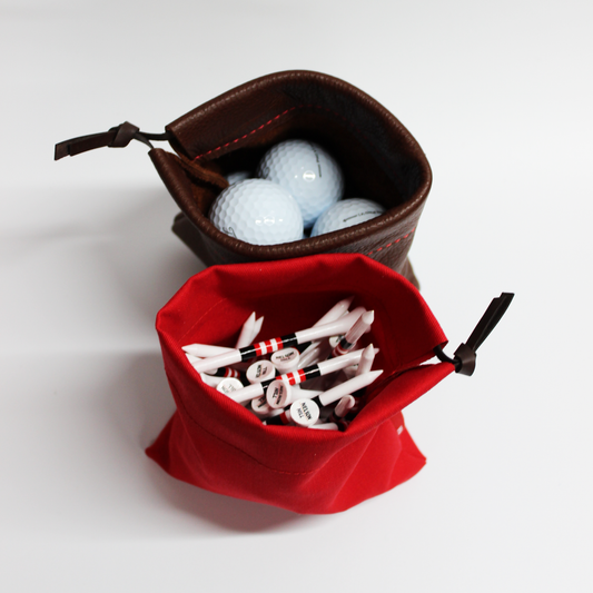 Brown drawstring bag with golf balls and red drawstring bag with golf tees on a white background