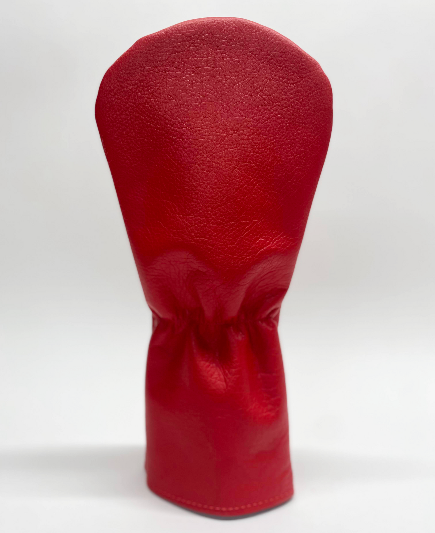 Red golf club head cover on a white background