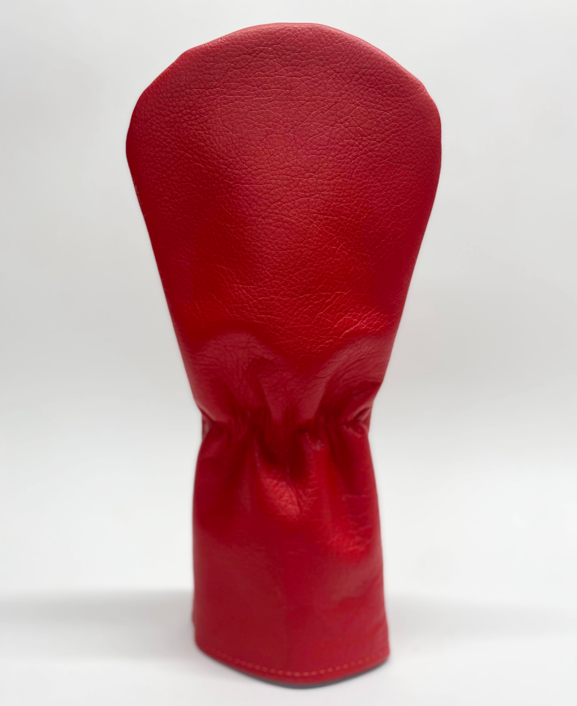Red golf club head cover on a white background