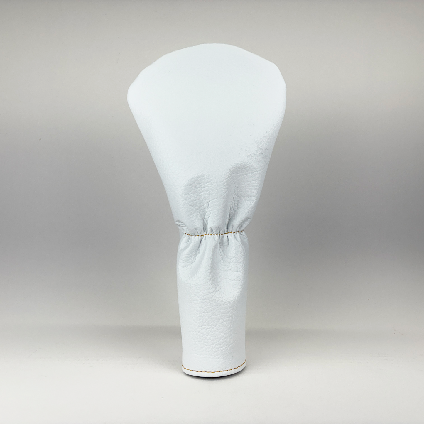 White golf club head cover on a gray background