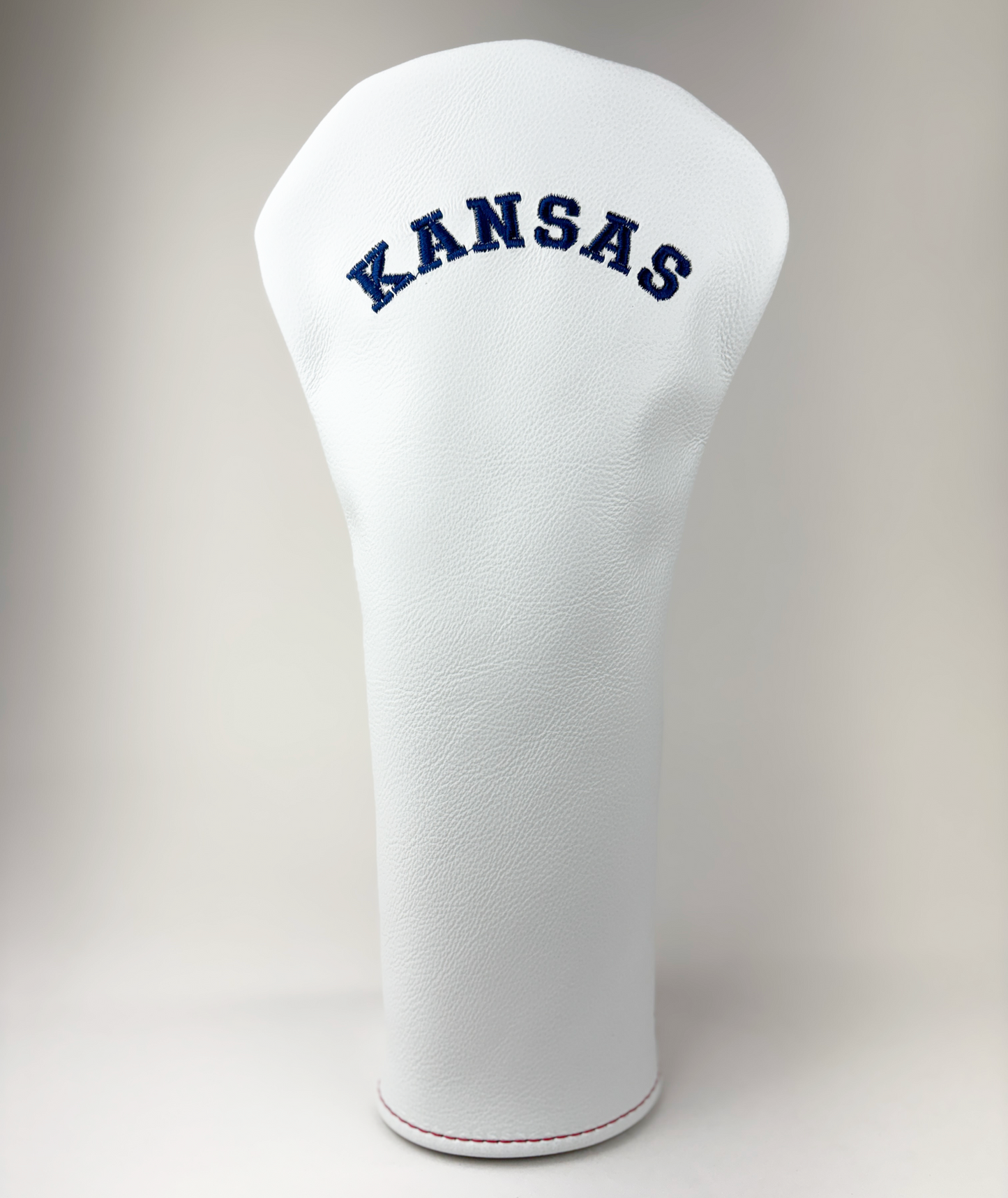 White golf club head cover with 'KANSAS' text on a light gray background