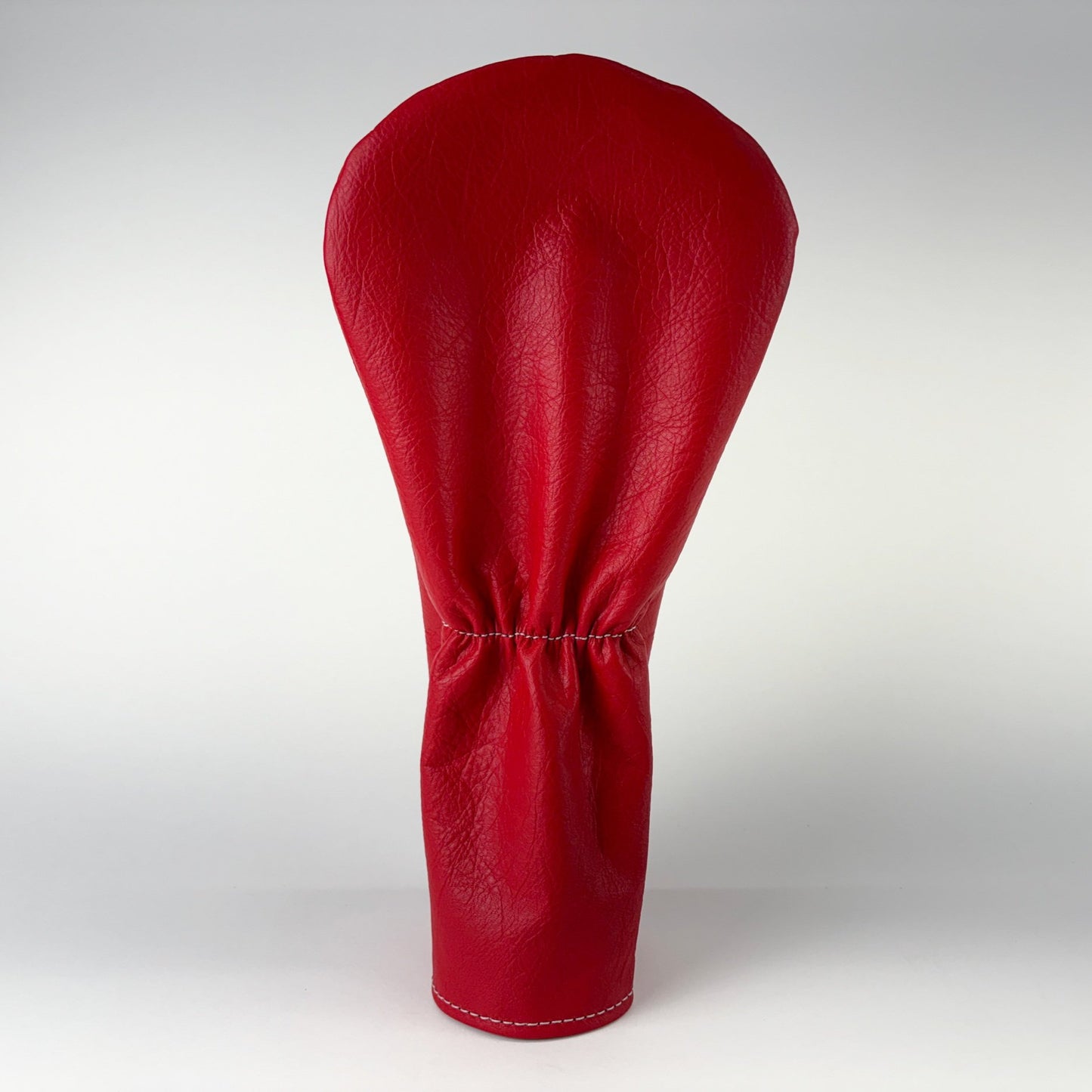 Red golf club head cover on a white background