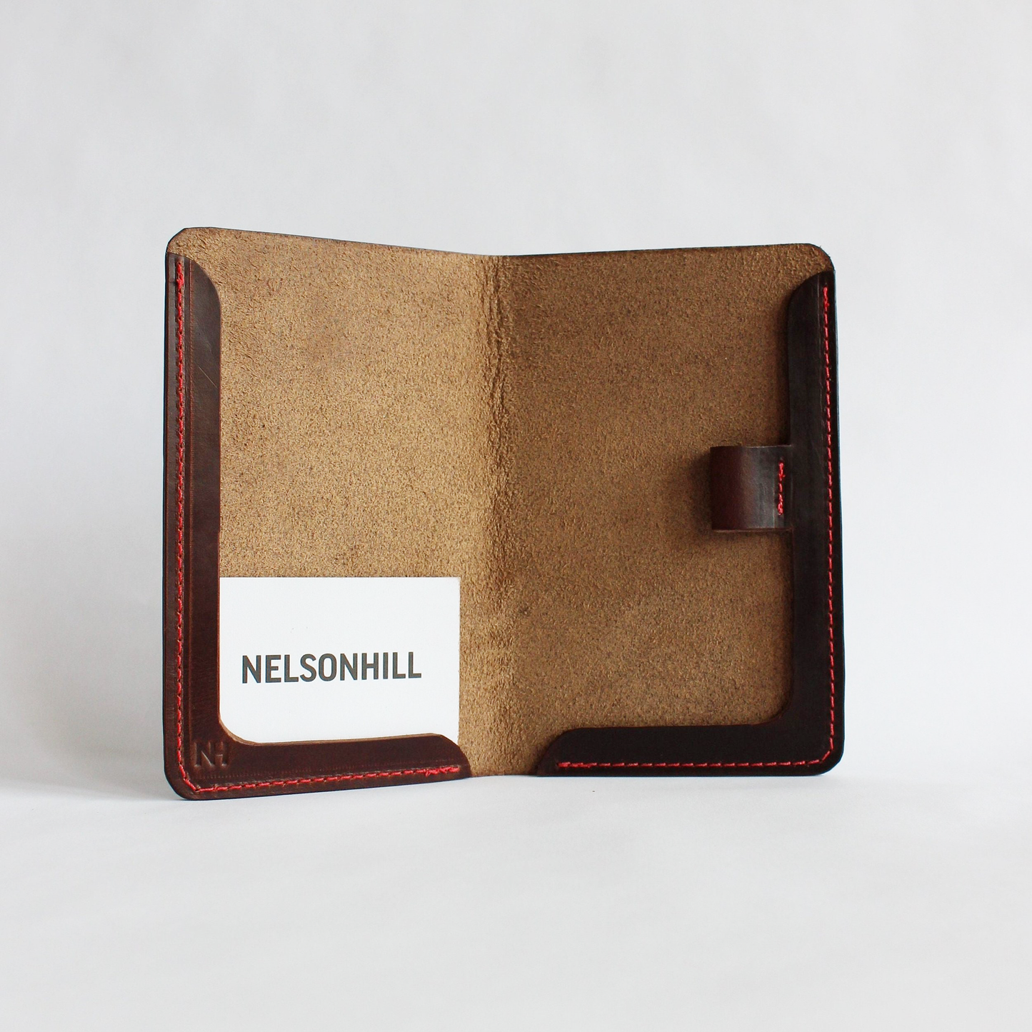 Brown leather scorecard holder with a white background