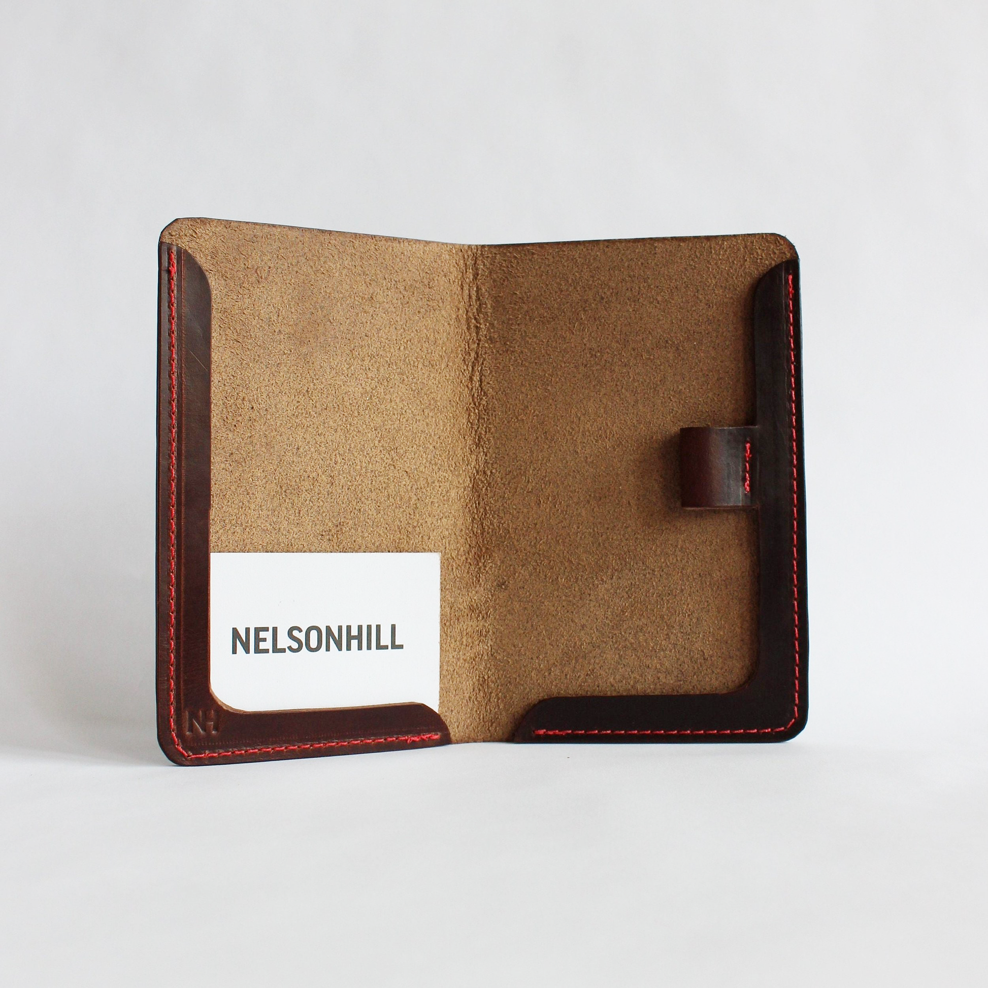 Brown leather scorecard holder with a white background
