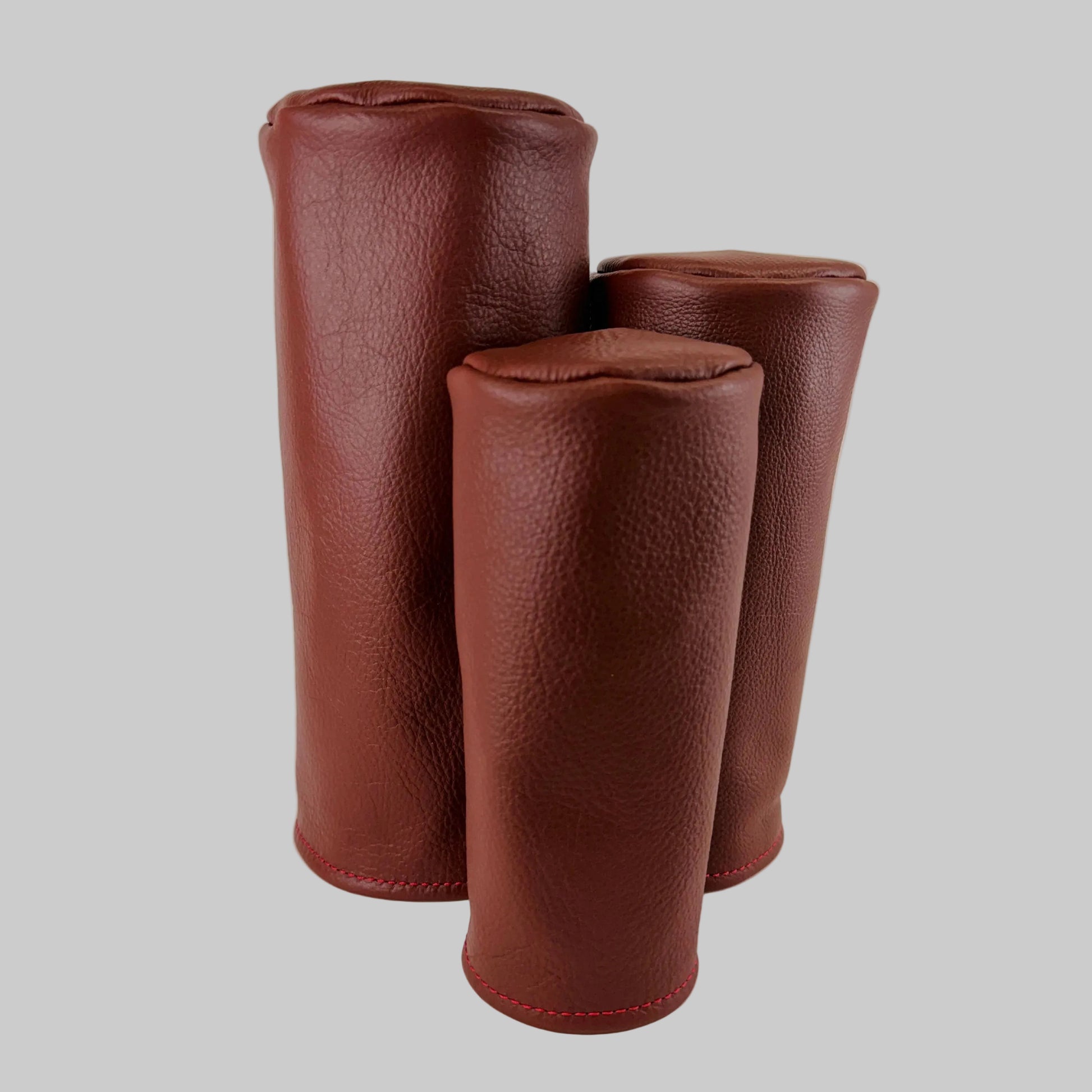 Brown barrel leather golf headcover set on a white background