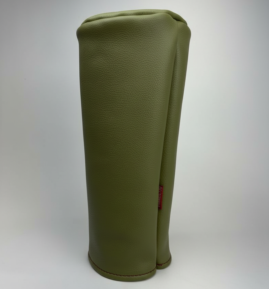 Green barrel leather golf headcover on a white background
