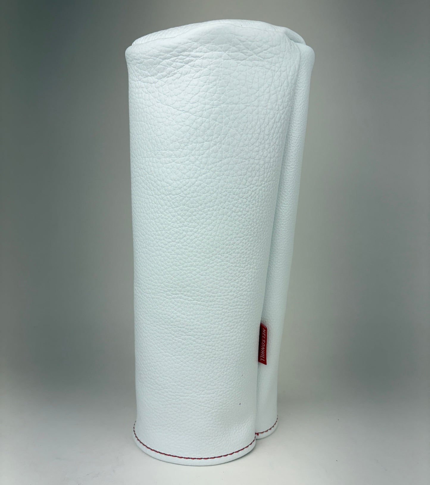 White barrel leather golf headcover on a white background