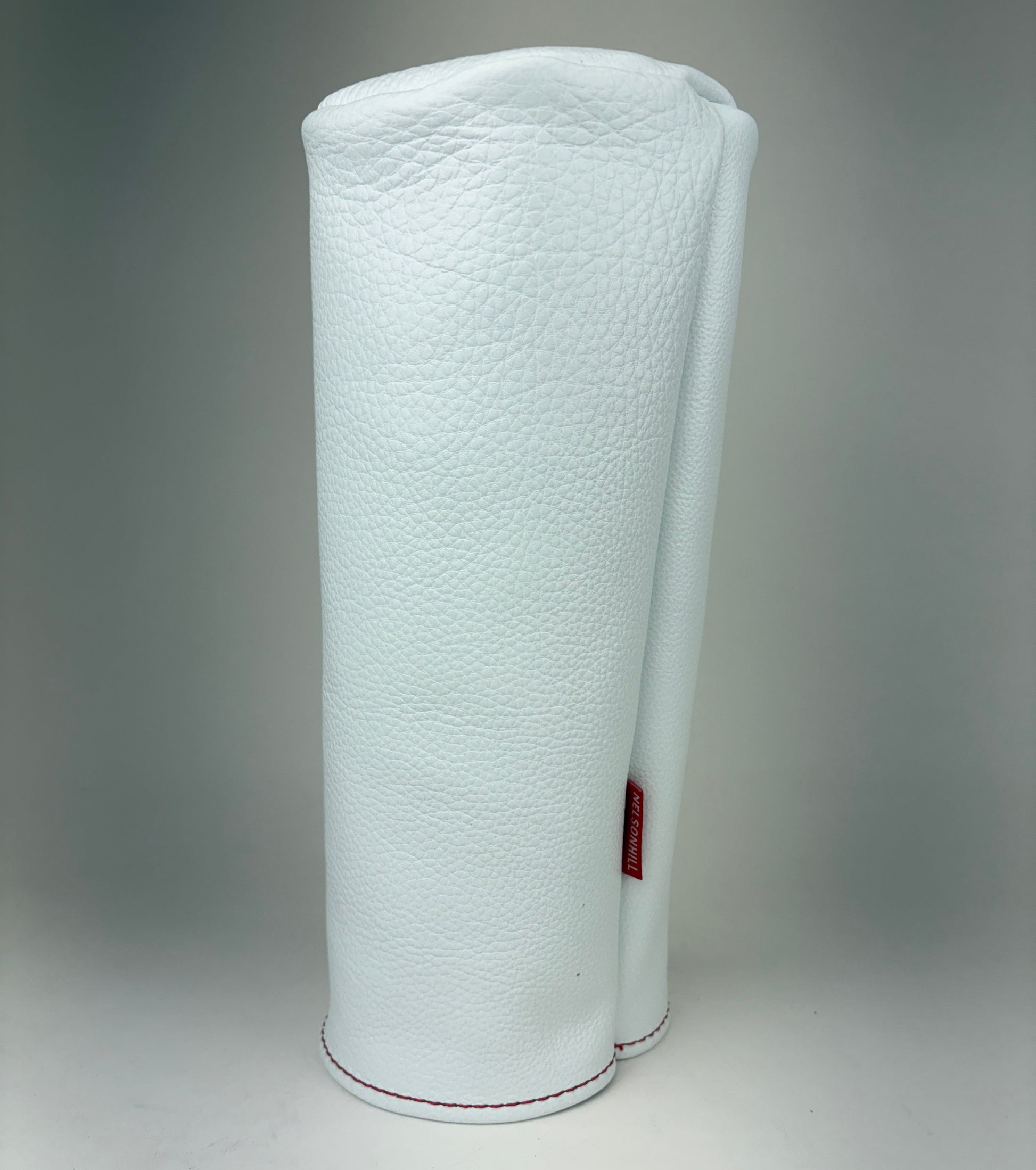 White barrel leather golf headcover on a white background